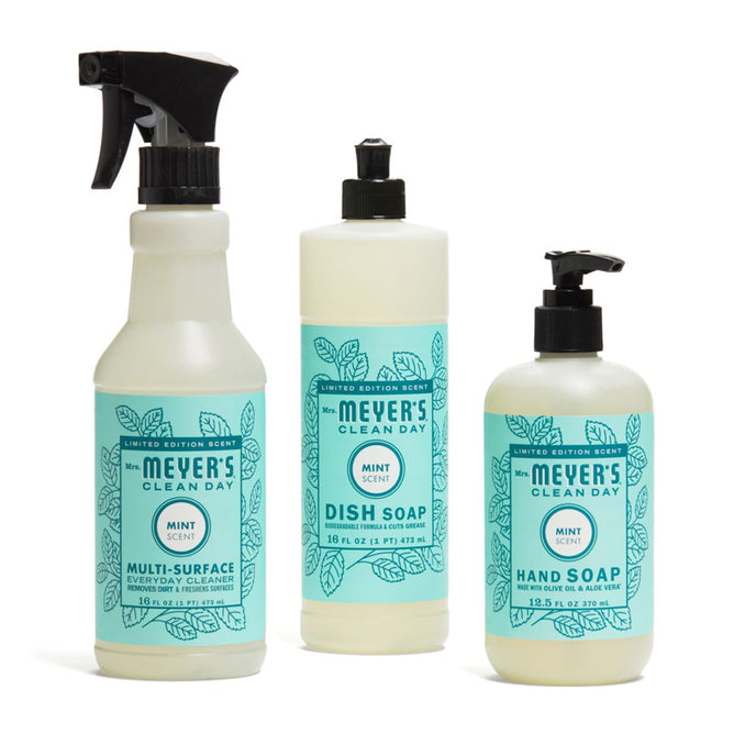 The Mrs. Meyer's Uplifting Spring Household Cleaning Set includes a mint-scented multi-surface cleaner, dish soap, and hand soap in light bottles with teal leaf-designed labels.