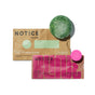 Two shampoo bars—one green and one pink—rest on packaging labeled NOTICE Hair Co, featuring the offer: Buy The Stimulator Shampoo Bar, Get ALINE Mini Conditioner Bar FREE. The Stimulator Shampoo Bar delivers a scalp clarifying experience, while the ALINE Mini Conditioner Bar gently nourishes your hair to meet its specific needs.