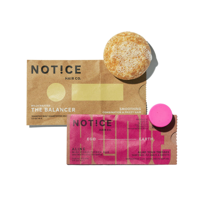 Two rectangular brown and pink wrappers labeled “NOTICE Hair Co” are displayed on a white background, each paired with a round bar: the orange Balancer Shampoo Bar and the magenta ALINE Mini Conditioner Bar, featured in the “Buy The Balancer Shampoo Bar, Get ALINE Mini Conditioner Bar FREE” offer from NOTICE Hair Co.