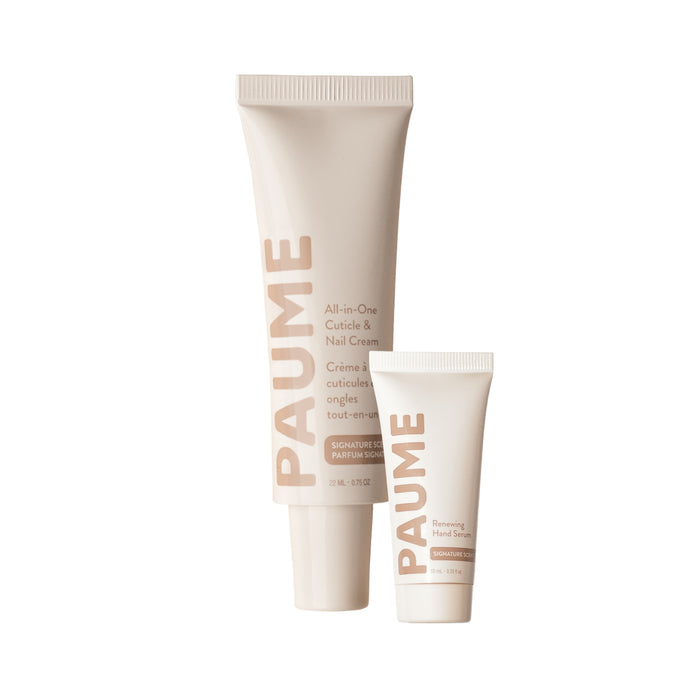 A large tube of PAUME All-in-One Cuticle & Nail Cream next to a smaller tube of Renewing Hand Serum for dry cuticles.