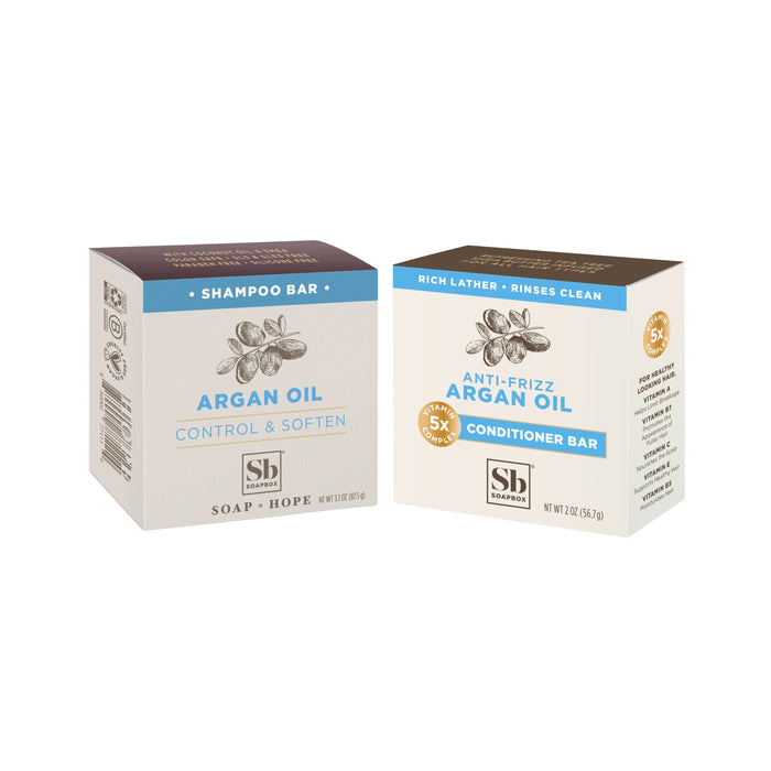 Soapbox Moroccan Argan Oil Haircare Set: includes an Argan Oil Shampoo Bar (Control & Soften) and an Anti-Frizz Conditioner Bar, both in brown and cream packaging with argan illustrations.
