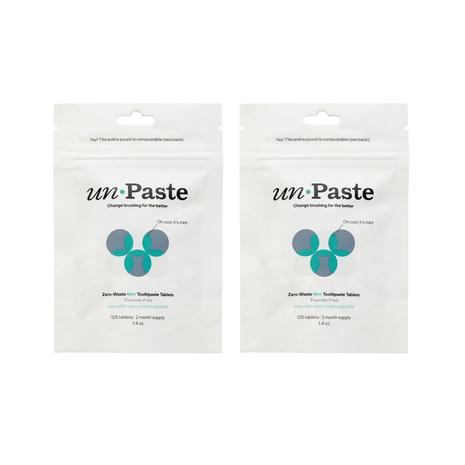 Two white Unpaste pouches labeled 