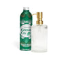 A green metal refill bottle labeled Grove Co. Hand Soap Starter Set – Winter Collection stands beside a clear, ribbed glass soap dispenser with a gold pump.