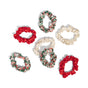 Six Holiday Ruched Satin Scrunchies Gift Set by Kitsch arranged in a circle on a white background, featuring red, cream, and plaid patterns.