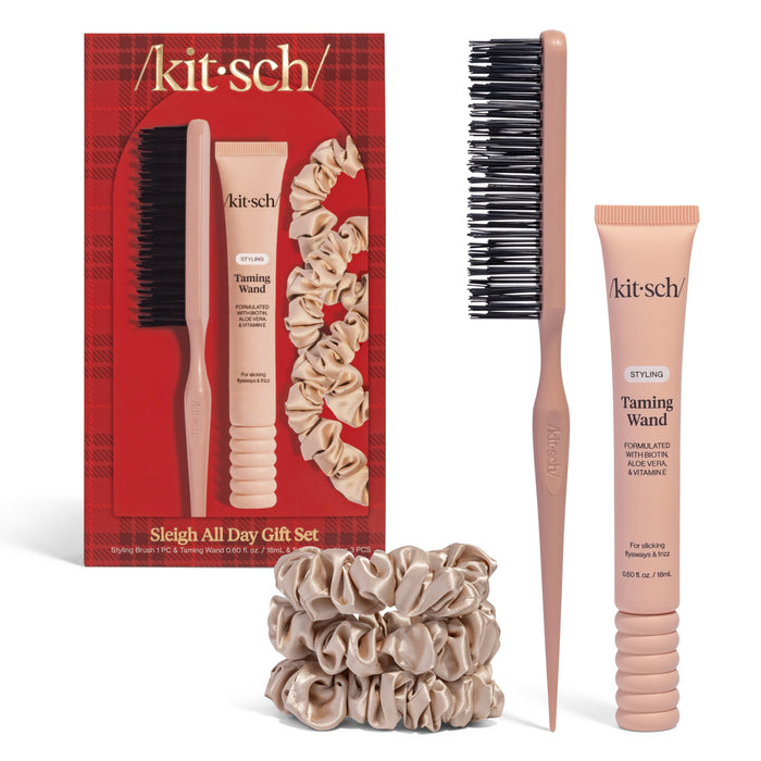 The Kitsch Hair Taming Sleigh All Day Gift Set includes a Styling Brush, Taming Wand, and beige Satin Scrunchies in festive red plaid packaging—perfect for sleek ponytails. Items also shown outside the box.