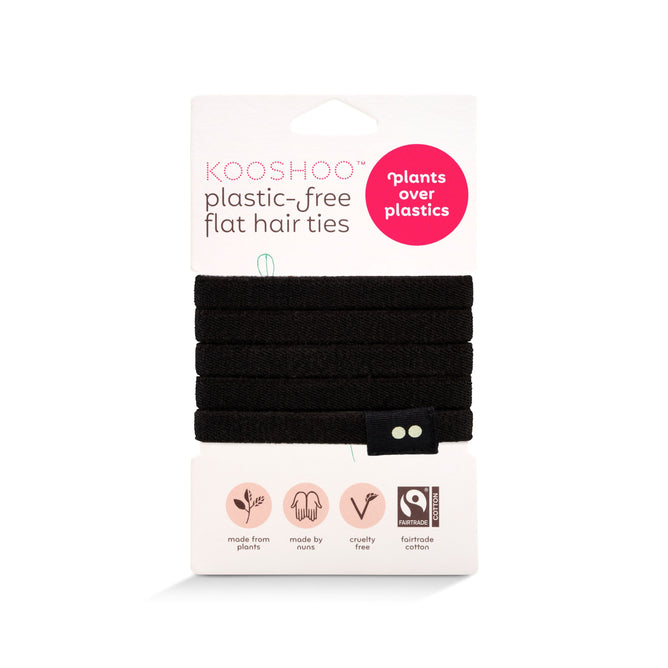 KOOSHOO Organic Hair Ties, in black, come plastic-free on cardboard packaging highlighting plant-based, cruelty-free, and fairtrade cotton. The pack shows “plastic-free flat hair ties” and “plants over plastics.”.