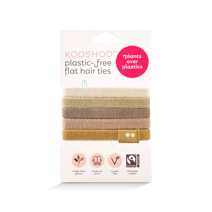 KOOSHOO Organic Hair Ties, ethically made from fairtrade cotton, come in earth tones with plastic-free, plant-based materials. The cardboard packaging reads “plants over plastics” and features cruelty-free and plant-based icons.