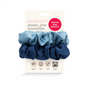 Two blue KOOSHOO Scrunchies—one light, one dark—made from organic cotton using Fairtrade, zero-waste methods. Packaging is eco-friendly and cruelty-free, emphasizing plants over plastics.