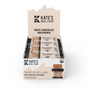 A display box of Kates Real Food Organic Energy Bar - White Chocolate Macadamia includes twelve gluten-free bars with organic oats and whole-food ingredients, each bar individually wrapped and labeled as USDA organic.