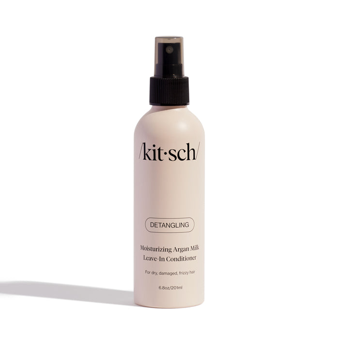 The Kitsch Moisturizing Argan Milk Leave-In Conditioner, housed in a beige 6.8 oz (201 ml) spray bottle, is ideal for dry, damaged, or frizzy hair. Infused with Actimilk™, it detangles while enhancing softness.