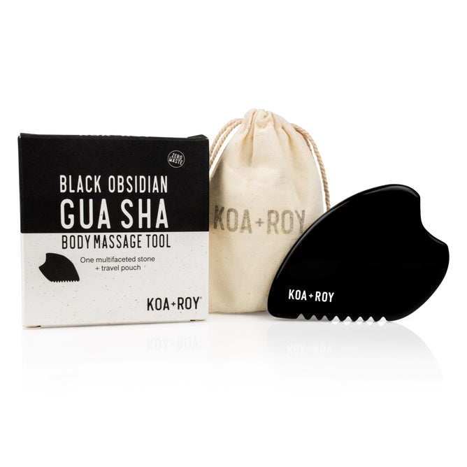 Large Black Obsidian Body Gua Sha Tool by KOA + ROY, shown with its box and beige drawstring pouch. Inspired by traditional Chinese medicine, it supports lymphatic drainage for a rejuvenating body massage.