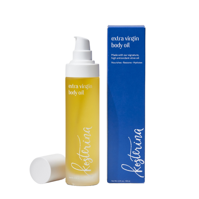 A bottle of Kosterina Extra Virgin Body Oil with a white cap and pump sits beside its blue box. The yellow oil and packaging are both labeled in white text.