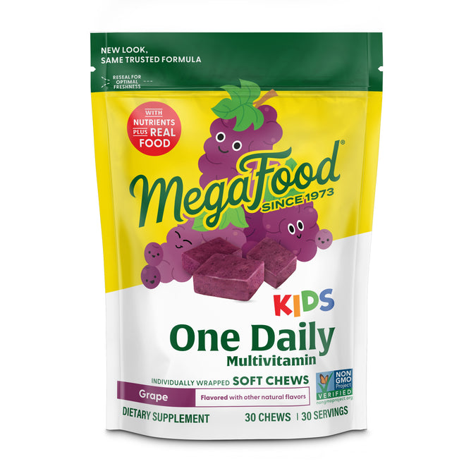 A colorful bag of MegaFood Kids One Daily Multivitamin Soft Chews in grape flavor, featuring cartoon grapes and purple chews. The package highlights Non-GMO, nutritional support, and nutrients plus real food.
