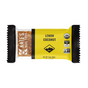 A wrapped Kates Real Food Organic Energy Bar - Lemon Coconut features a yellow and black label with USDA Organic, Gluten Free, and Non-GMO certifications. Made with organic oats, the energizing bar is partially visible through the packaging.