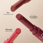 The RMS Beauty Legends to Love Kit displays three full-size Serum Lipsticks—Eve (rosy-red nude), Josephine (rich cranberry), and Miranda (classic soft rose)—arranged diagonally on a beige background.