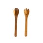 Two sustainably sourced utensils by LIKHA on a white background: the Acacia Essential Serving Set includes a wooden spoon on the left and a Fair Trade, two-pronged spork on the right.