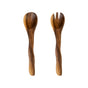 On a white background: LIKHA’s Acacia Essential Serving Set with Wiggly Handles, handcrafted from sustainably sourced acacia wood—a spoon on the left and a matching two-pronged fork on the right.