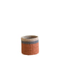 The LIKHA Abaca Cylinder Tabletop Basket is a small, round basket made from Abaca fiber with beige, gray, and rust orange bands. Ethically crafted, it stands out against a plain white background.