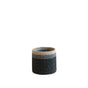 The LIKHA Abaca Cylinder Tabletop Basket is a small, round basket handcrafted from abaca fiber with a dark base, gray middle, and light tan top band, shown against a plain white background.