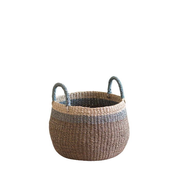 The LIKHA Abaca Bulge Basket, expertly crafted from manila hemp, features two handles, a natural brown color with a blue-gray band near the top, and is displayed against a plain white background.