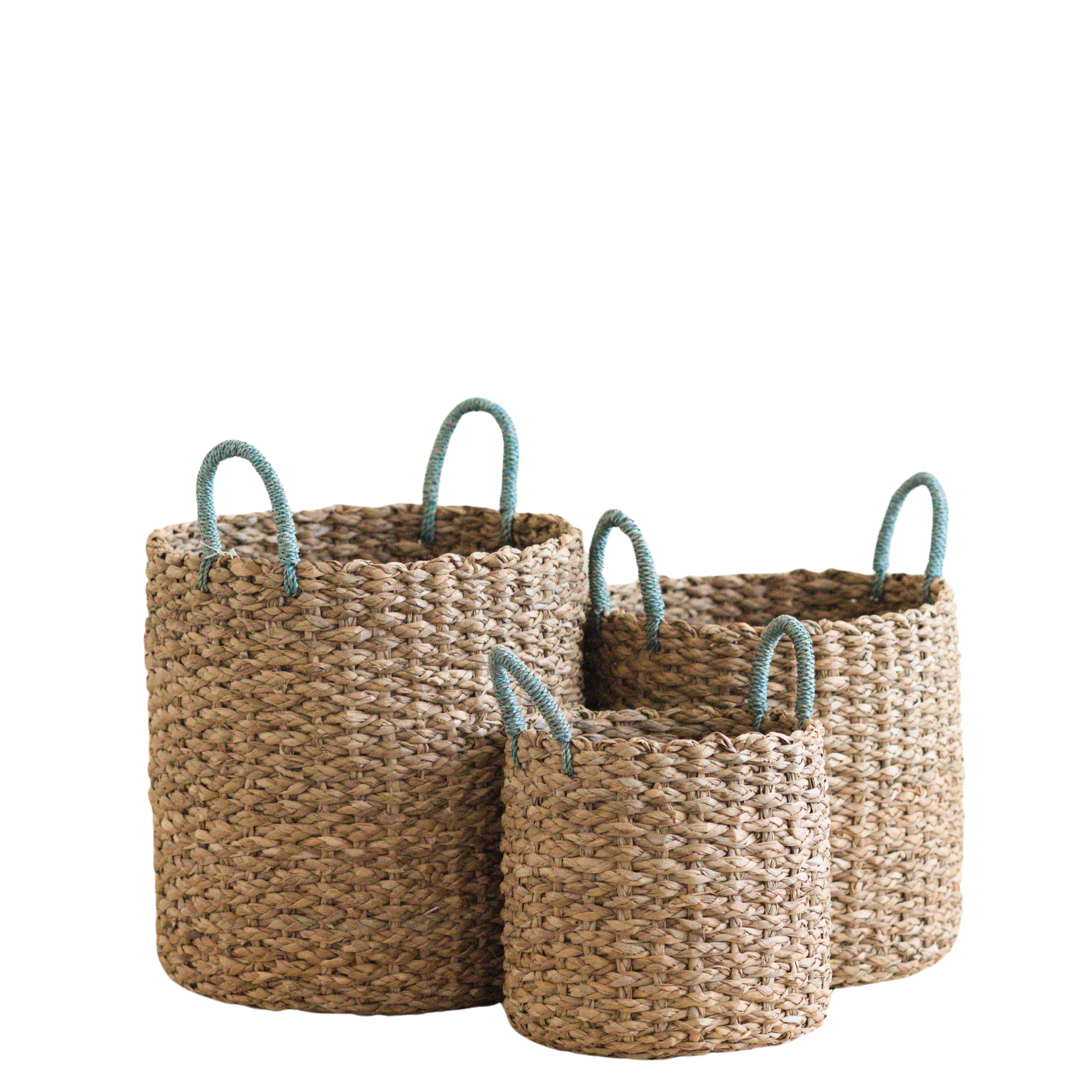 The LIKHA Seagrass Cylinder Basket with Handles is a nested set of 3, each ethically made and beautifully crafted for stylish storage solutions. Sky blue handles add a pop of color, blending style and function seamlessly. Displayed against a white background.