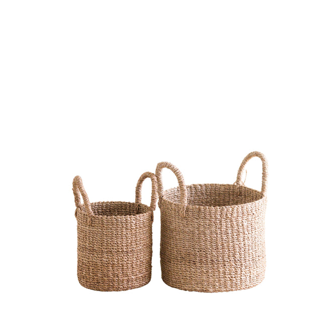 The LIKHA Abaca Cylinder Tabletop Basket with Handles, a nested set of 2 in mini and large sizes, is crafted from natural Manila hemp and features sturdy handles for easy carrying.