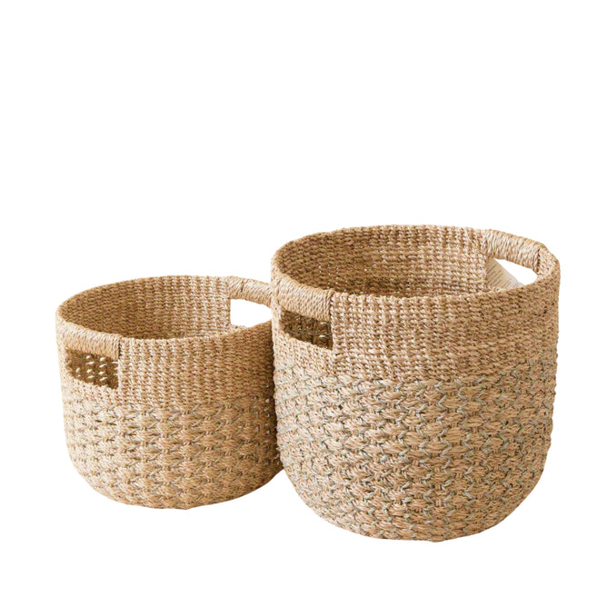 The LIKHA Abaca Round Bottom Basket, nested set of 2, features two sustainably crafted baskets in grey and natural hues with handles—an elegant Fair Trade Federation piece displayed side by side on a white background.