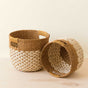 The LIKHA Abaca Round Bottom Basket, nested set of 2, features handwoven natural Manila hemp in two-tone light and dark brown patterns with side handles. Crafted by Fair Trade Federation members.
