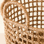 A close-up of the LIKHA Seagrass Rope Open Weave Cylinder Basket, part of a nested set of 3 with handles, showcases its natural seagrass construction and open grid pattern against a neutral background.