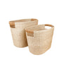 The LIKHA Abaca Rounded Oval Basket set of 2 features handcrafted baskets made from natural materials in beige and light brown, shown side by side on a white background for sustainable storage.