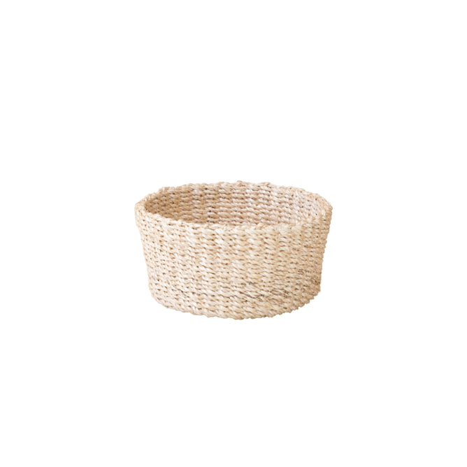 The Abaca Mini Trinket Basket by LIKHA is a handcrafted, small round tray made from sustainable, light-colored abaca straw, elegantly displayed on a plain white background.