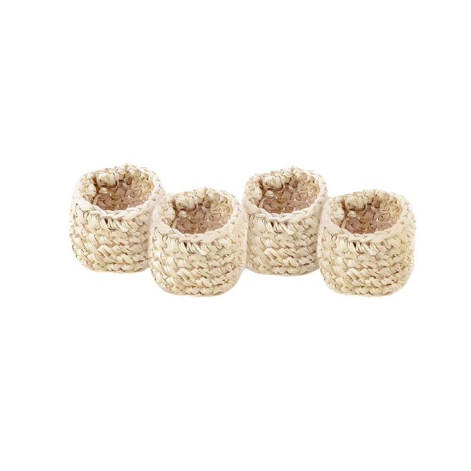 The LIKHA Raffia Napkin Rings, set of 4, are displayed in a row on a white background, highlighting their rustic elegance and natural raffia crochet craftsmanship.