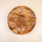 The LIKHA Acacia Serving Tray 5-Compartment features a round, segmented design with five outer sections and a central compartment, crafted from sustainably sourced wood and shown on a light wood surface.