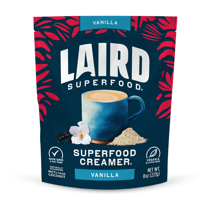 A blue package of Laird Superfood Vanilla Superfood Creamer shows a coffee cup, real vanilla extract, vanilla pods, and creamer powder. The packaging highlights that it is vegan, gluten-free, and non-GMO.