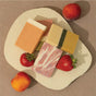 The Pacha Soap Co. Bar Soap Set - Summer Garden features four vibrant rectangular artisanal soaps, artfully arranged with fresh strawberries and a peach on a cream-textured surface against a taupe background.