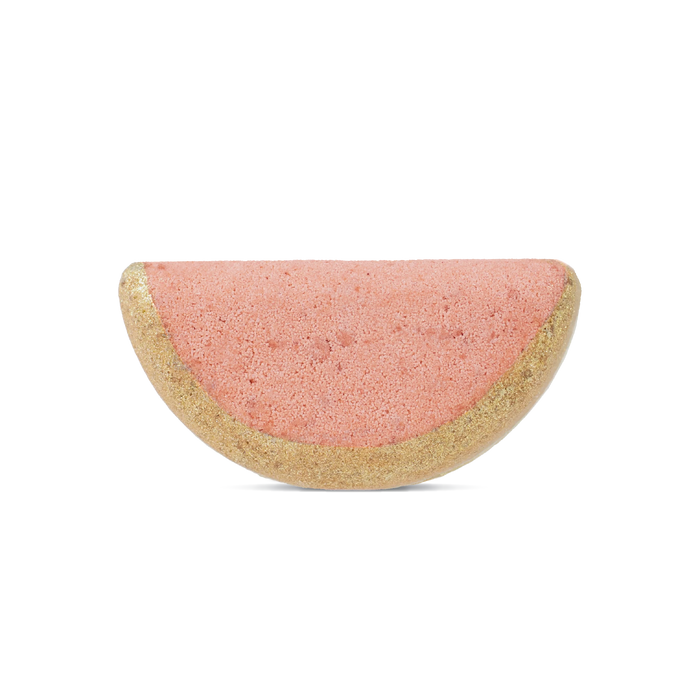 The Pacha Soap Co. Watermelon & Mint Bath Bomb, shaped like a watermelon slice with a pink center and glittery gold rind, infuses nourishing plant oils for soft skin—perfect for your next relaxing soak. Displayed on a plain white background.