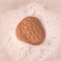 The Strawberry & Basil Bath Bomb by Pacha Soap Co. fizzes in the water, creating bubbles and a creamy bath surface enriched with nourishing plant oils and cocoa butter for an indulgent strawberry soak.