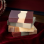 A stack of four Bar Soap Set - Heritage Holiday Collection soaps featuring multicolored, marbled patterns.