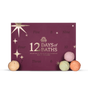 A deep purple 12 Days Of Baths Advent Calendar box with twelve perforated windows, gold lettering, and star accents, with three moisturizing bath bombs placed in front.