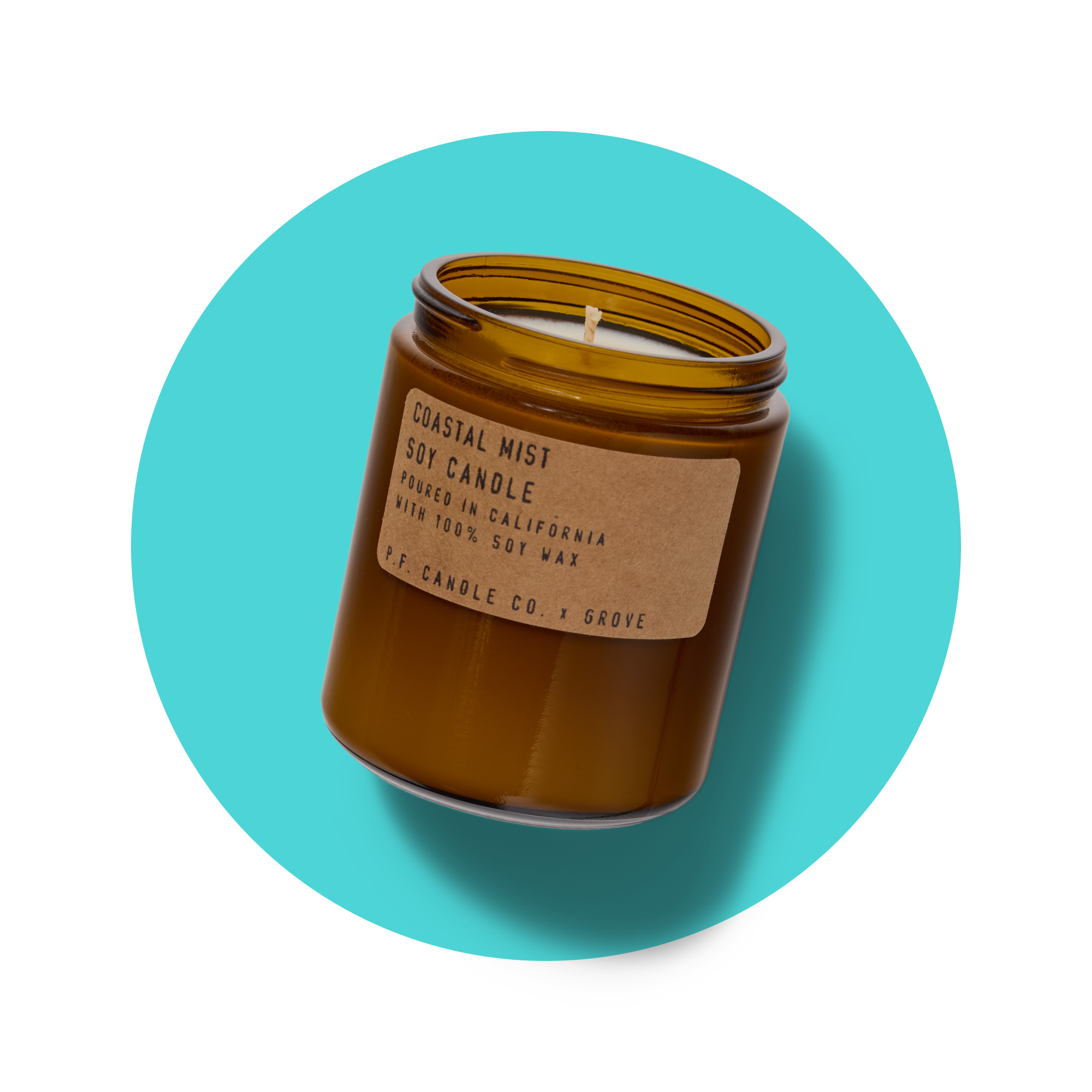 A brown glass jar soy candle with a tan label reading Coastal Mist Soy Candle on a turquoise circular background. The candle has a single wick and is made by P.F. Candle Co.