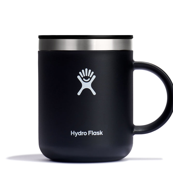 The 12 oz Hydro Flask Stainless Steel Mug features a black design with a silver rim, sturdy handle, and prominent white logo of a stylized figure on the front. It includes Hydro Flask text, making it stylish and durable.