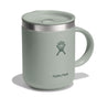 The 12 oz Hydro Flask Stainless Steel Mug in light green features a handle, embossed logo, and a splash-resistant lid for secure grip, casting a subtle shadow on the white background.