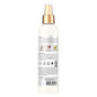 Back view of a white SheaMoisture spray bottle with a gold cap, displaying product details, icons, and images of ingredients such as coconut milk and acacia. Labeled as “100% Virgin Coconut Oil Leave in Treatment,” this hair detangling leave-in formula is enriched with virgin coconut oil. The lower portion of the bottle features printed text and a barcode.