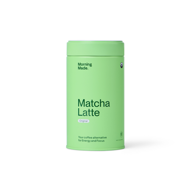 A light green cylindrical container labeled Morning Made Matcha Latte - 60 servings, featuring ceremonial grade matcha packed with antioxidants. Sleek, modern packaging reads: Your coffee alternative for energy and focus.