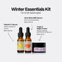 The Winter Hydration Gift Set, featuring two amber glass dropper bottles of Vitamin C and AHA+BHA hydrating serum next to a jar of Triple C night cream, with labels describing their skincare benefits.