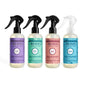 Four bottles of Mrs. Meyer's Room Freshener Spring Collection are lined up side by side, each featuring a pastel label in lilac, mint, rose, or dewdrop scent and topped with a black or clear spray nozzle.