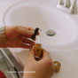 A person holds a black spool of Me Mother Earth Eco Floss Refills and a bamboo container over a sink. Text: *Container sold separately. Perfect zero waste refills for your dental floss.