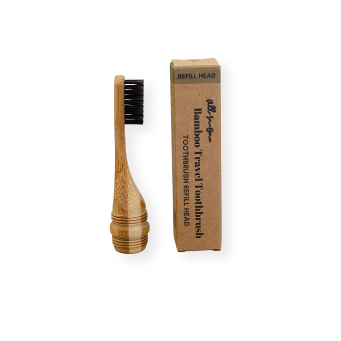 A Me Mother Earth All-in-One Bamboo Travel Toothbrush 2.0 Head - Refill with charcoal bristles sits next to a brown box labeled with the product name.