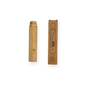 The Me Mother Earth All-in-One Bamboo Travel Toothbrush with Castor Oil Bristles stands next to its brown cardboard packaging, which shows a simple line drawing of the case and toothbrush against a clean white background.