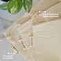 Three beige Me Mother Earth Cotton Muslin Bulk Shopping Bags are displayed on marble, each with a tare weight tag. Text highlights the drawstring, wooden bead, and tare weight features.